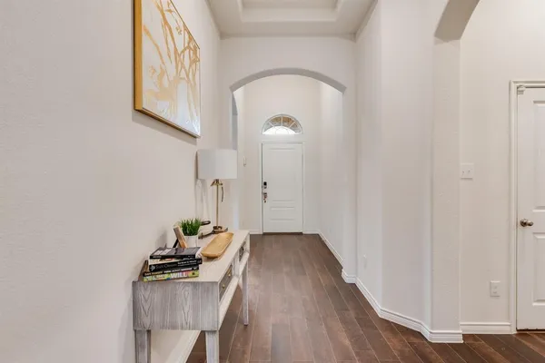 a hallway with table and flowerpot
