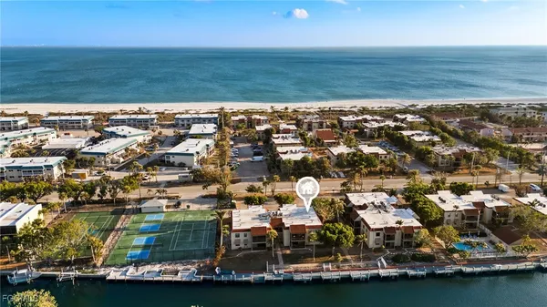 an aerial view of residential building with ocean