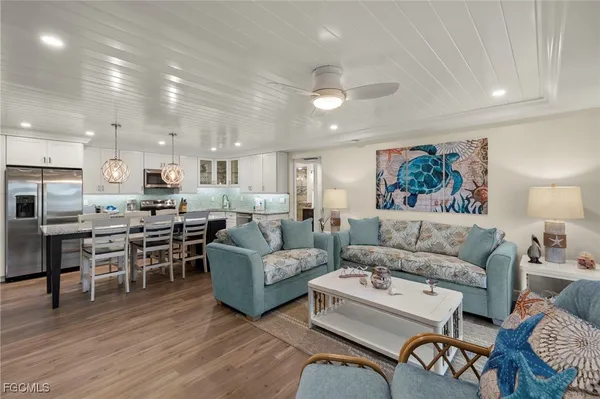 a living room with furniture kitchen view and a dining table