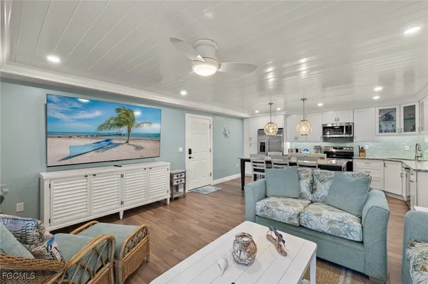 a living room with furniture and kitchen view