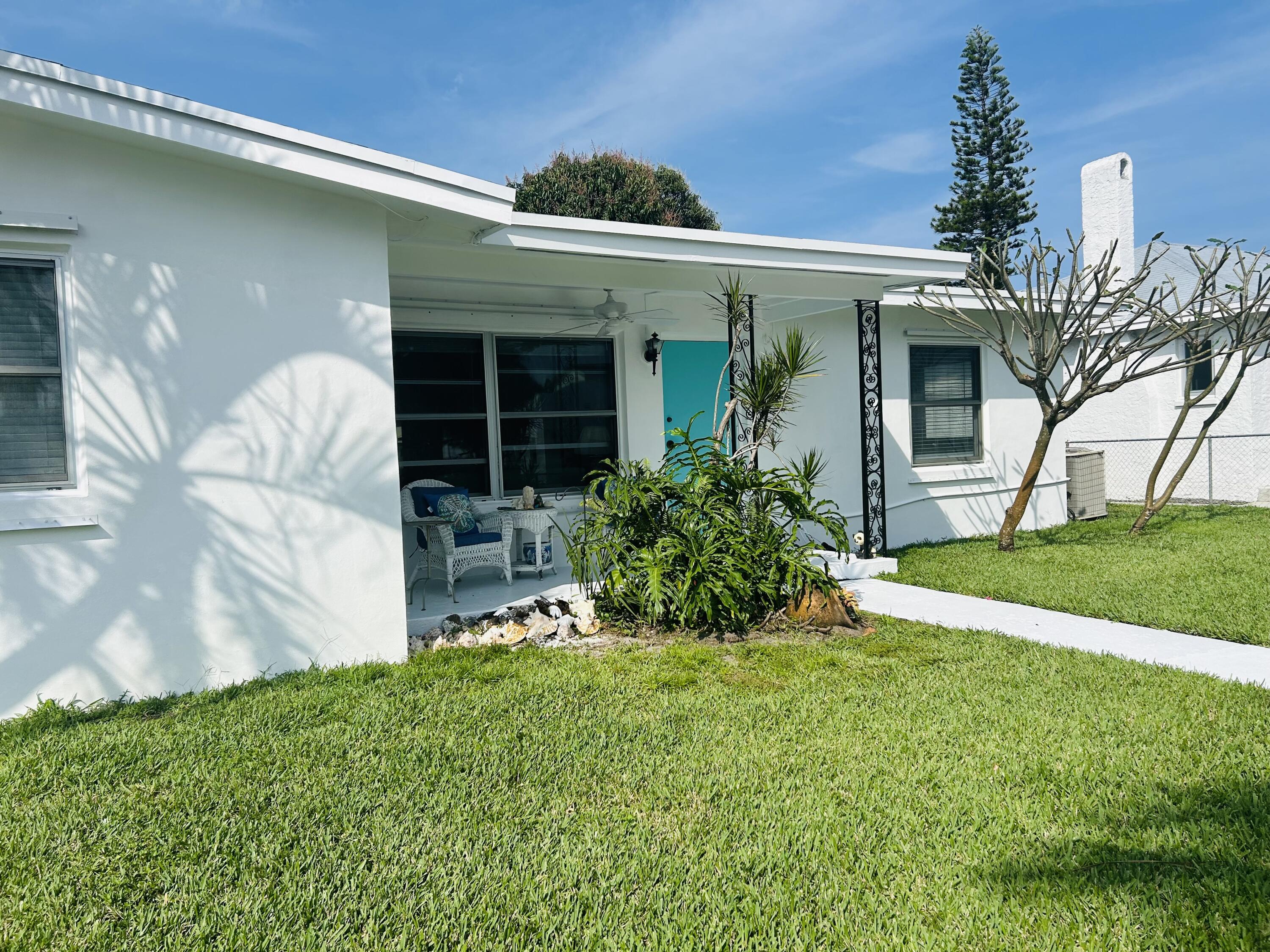 445 Monroe Drive West Palm Beach, FL 33405 - Photo 17 of 20 a front view of a house with garden