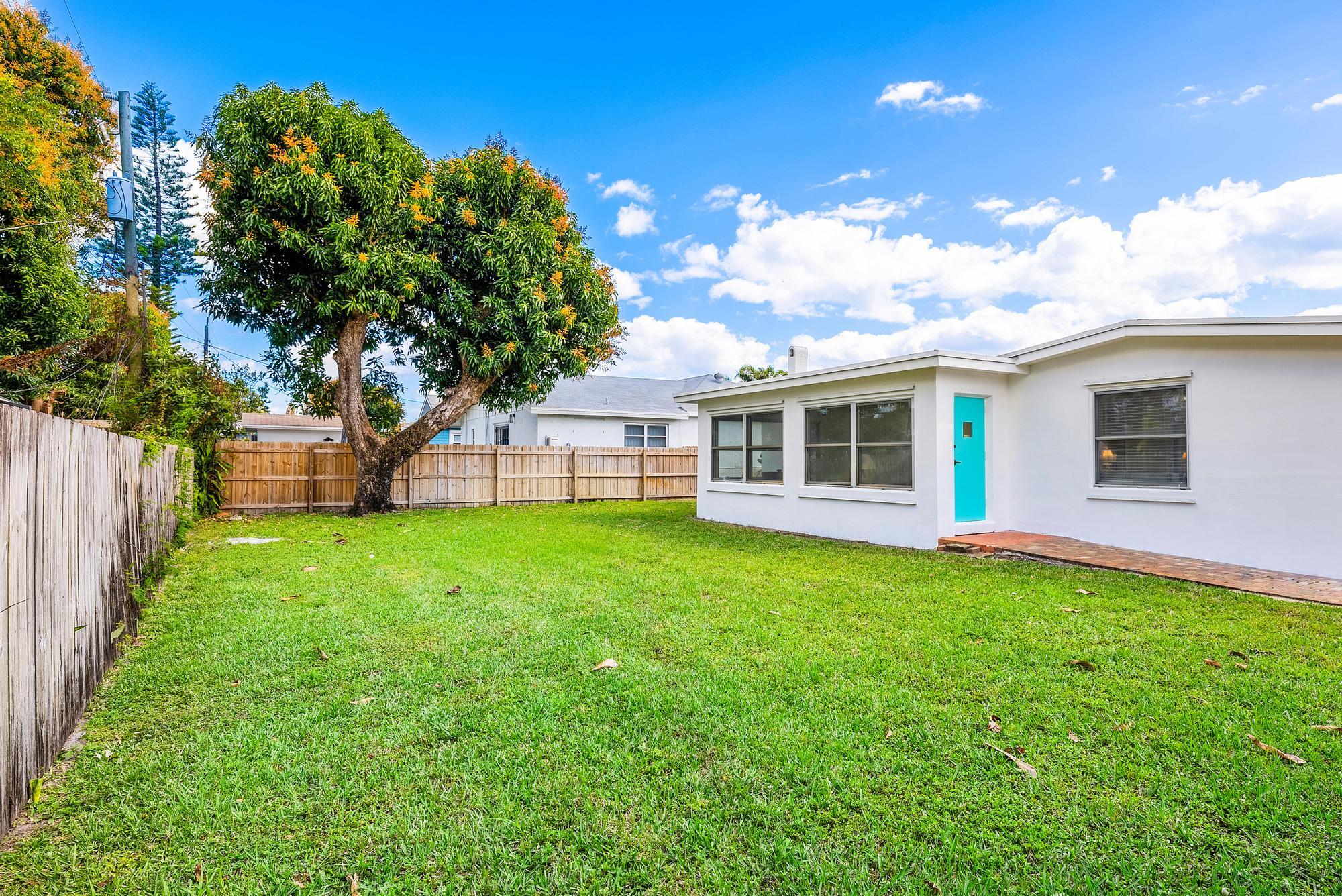 445 Monroe Drive West Palm Beach, FL 33405 - Photo 3 of 20 a view of a house with backyard and garden