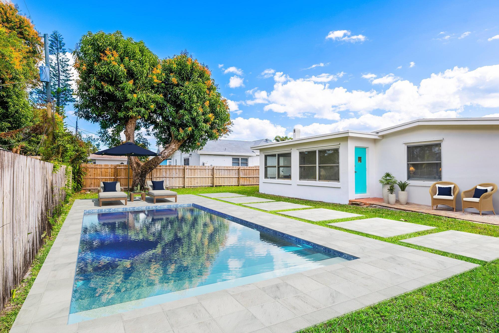 445 Monroe Drive West Palm Beach, FL 33405 - Photo 4 of 20 a view of a house with swimming pool and sitting area