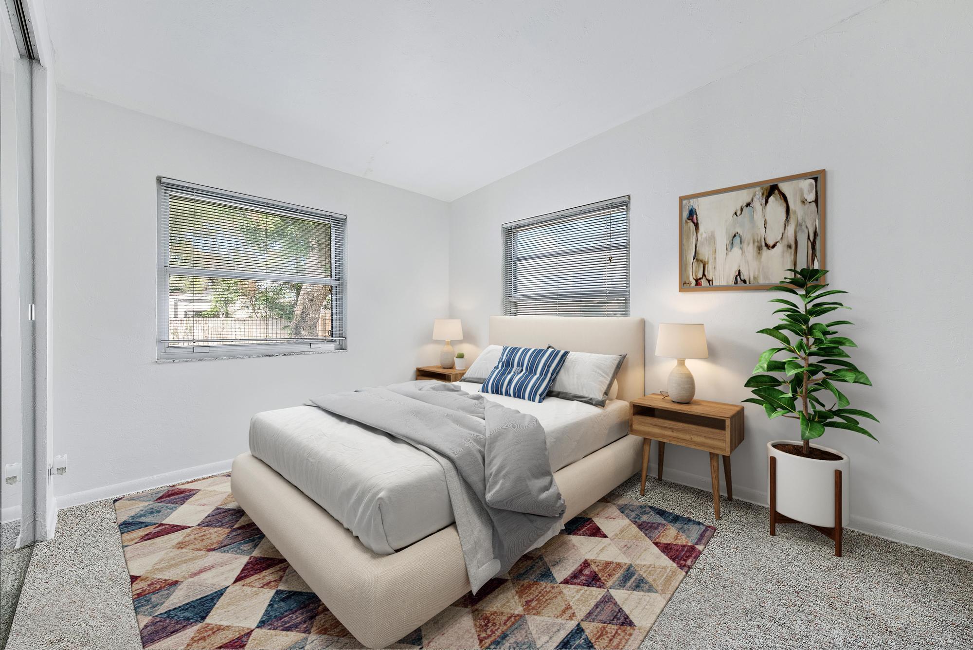 445 Monroe Drive West Palm Beach, FL 33405 - Photo 6 of 20 a bedroom with a large bed and a potted plant