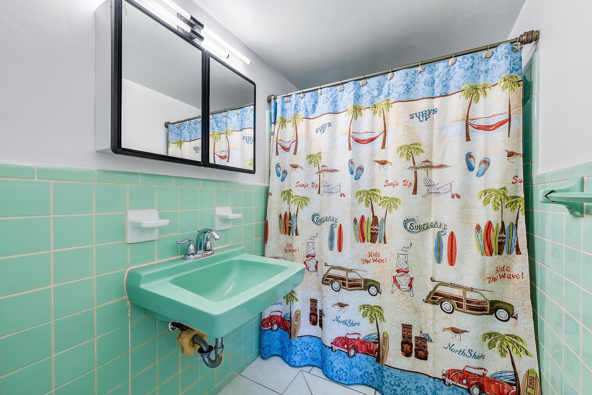 445 Monroe Drive West Palm Beach, FL 33405 - Photo 7 of 20 a bathroom with a sink a mirror and a shower curtain