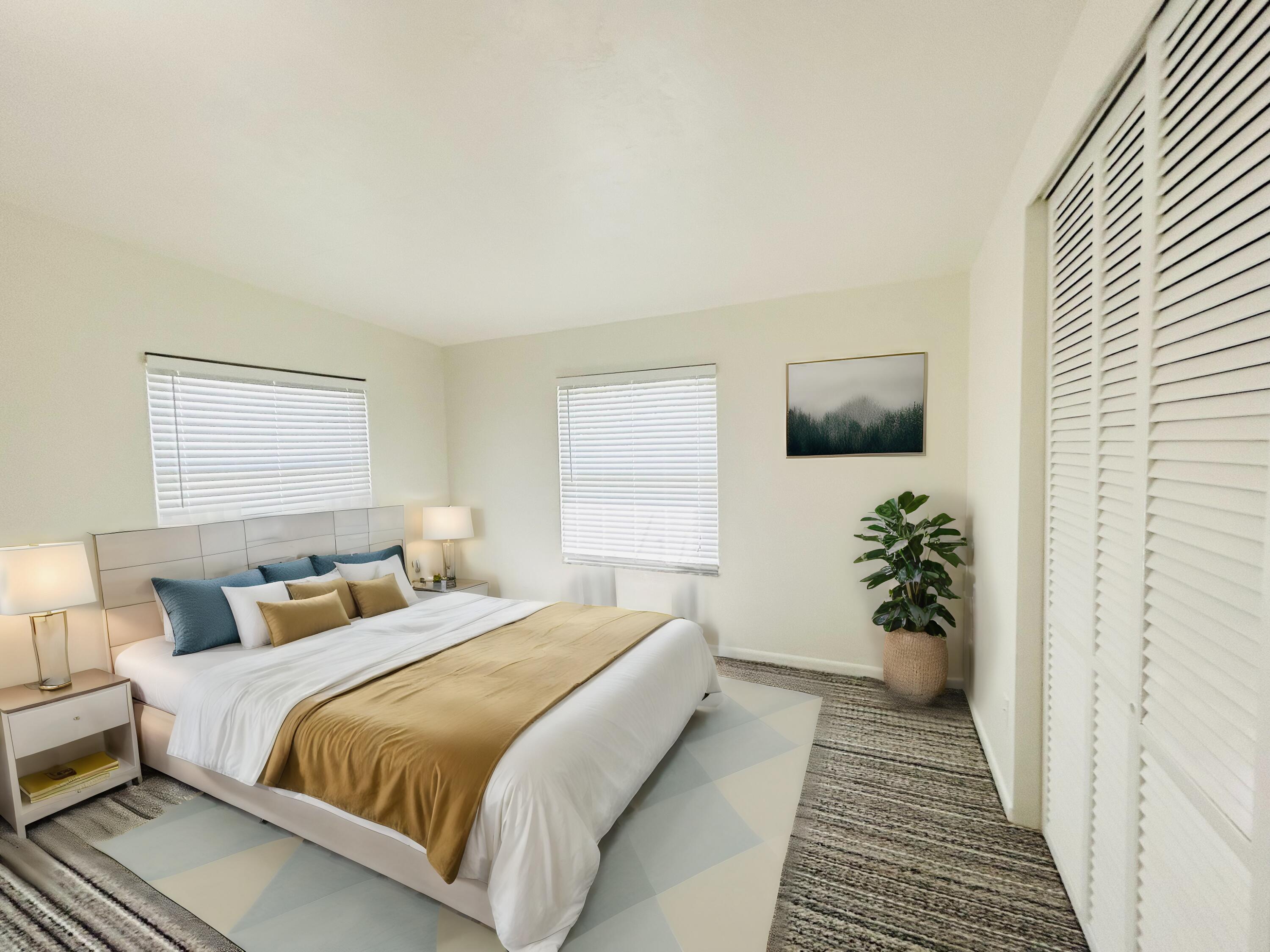 445 Monroe Drive West Palm Beach, FL 33405 - Photo 8 of 20 a bedroom with a large bed and a potted plant