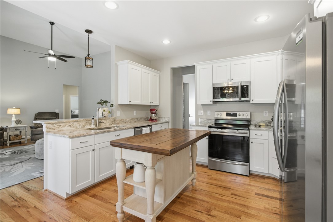 105 Winterbrook Circle Seneca, SC 29678 - Photo 16 of 48 This bright kitchen features wood flooring and a kitchen island with additional counter space.