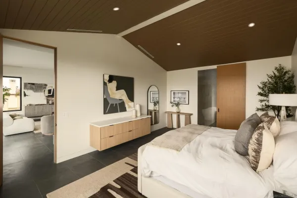 a bedroom with a bed and a large mirror