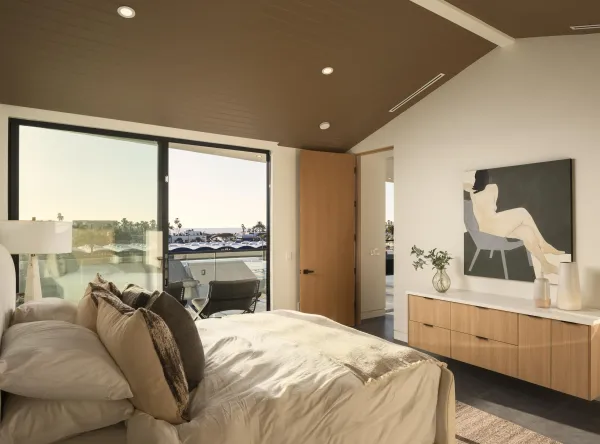 a bedroom with a bed and a large window