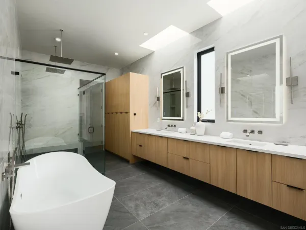 a bathroom with a double vanity sink toilet mirror and bathtub