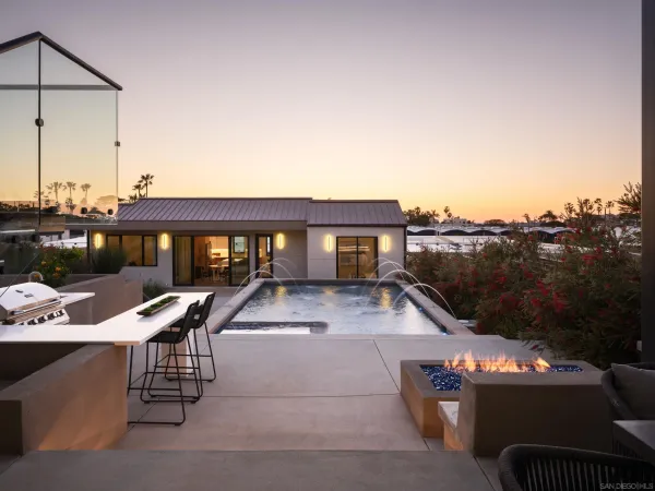 a view of a patio with couches table and chairs and potted plants