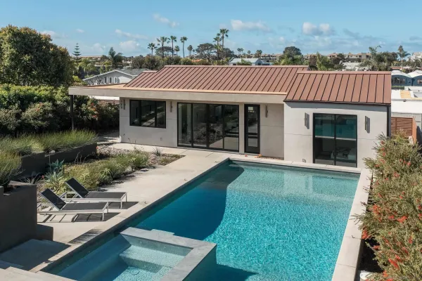 a view of a house with garden and patio