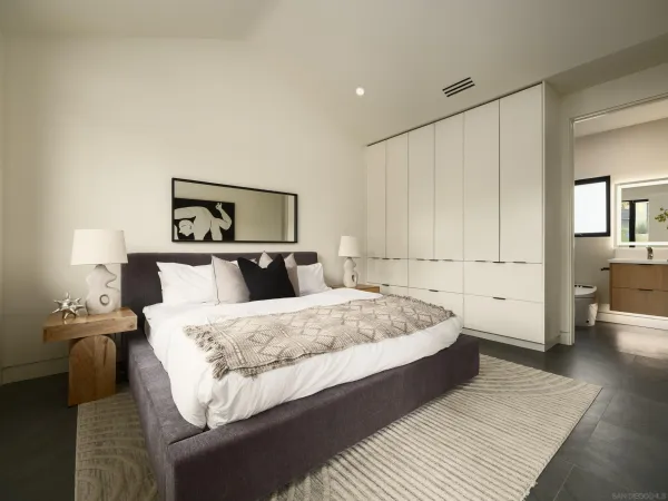 a bedroom with a bed and a couch