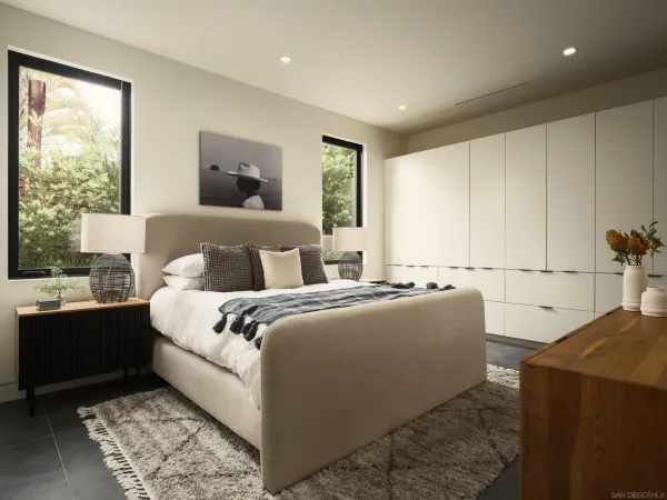 a bedroom with a large bed and a window