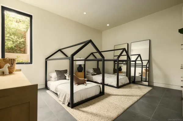 a bedroom with furniture and wooden floor