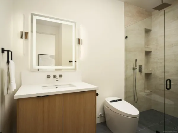 a bathroom with a toilet sink and mirror