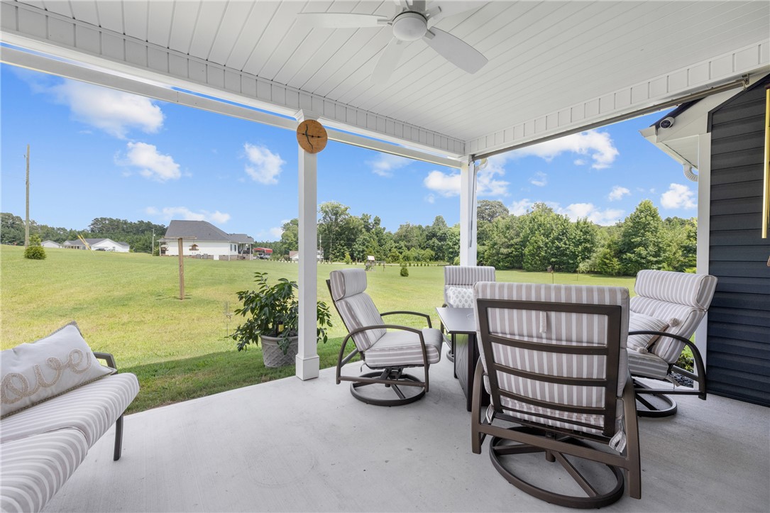 422 Mountain View Church Road Six Mile, SC 29682 - Photo 34 of 40 Enjoy idyllic views of the expansive yard from this covered patio, perfect for outdoor relaxation.