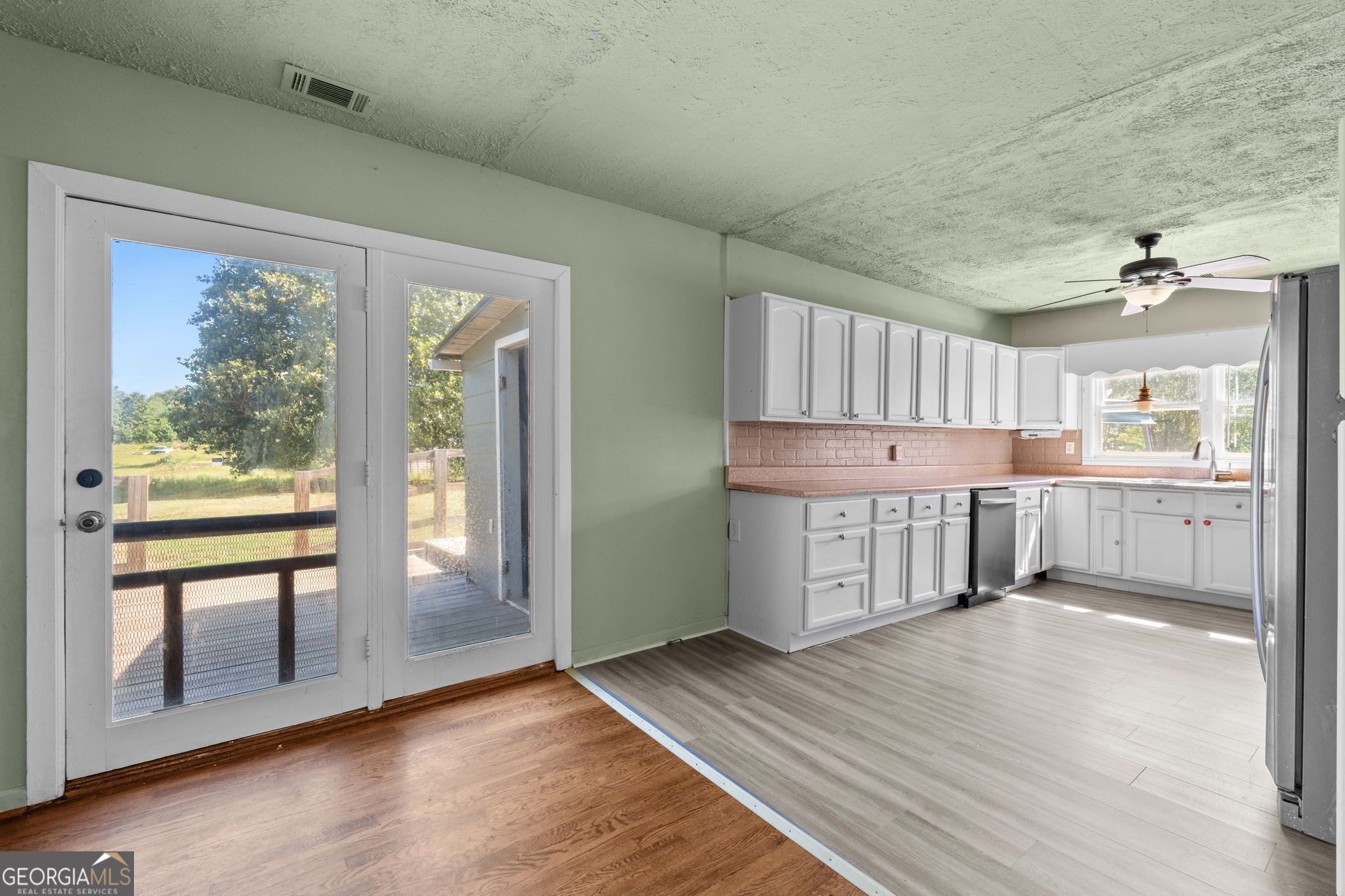 49 Frost Road Bowdon, GA 30108 - Photo 11 of 60 a view of kitchen with wooden floor and windows
