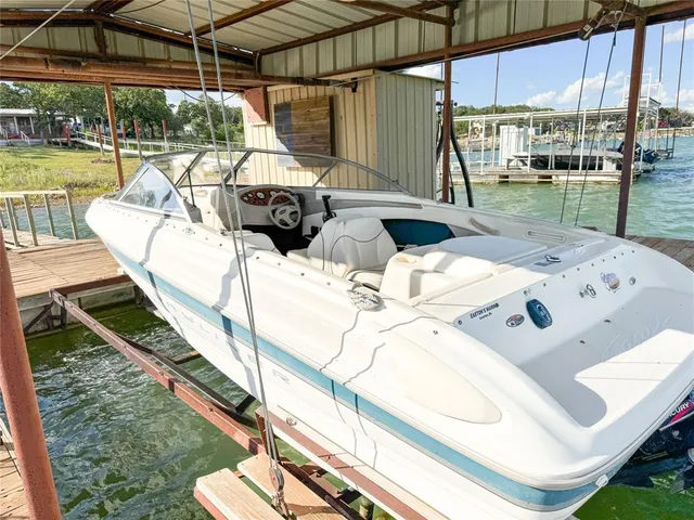 a view of a dining room with furniture a chandelier and wooden floor