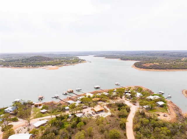 a view of a livingroom with lounge chair and a large window