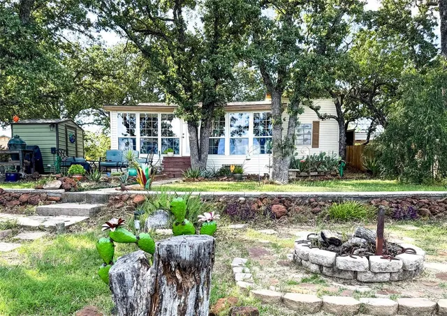 a front view of a house with a yard table and chairs
