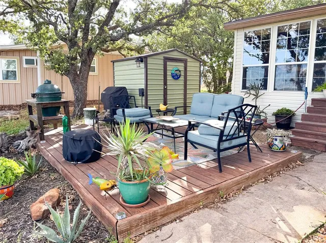 a view of a house with backyard and sitting area