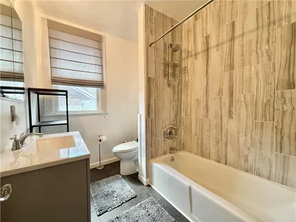 a bathroom with a sink a toilet and bathtub