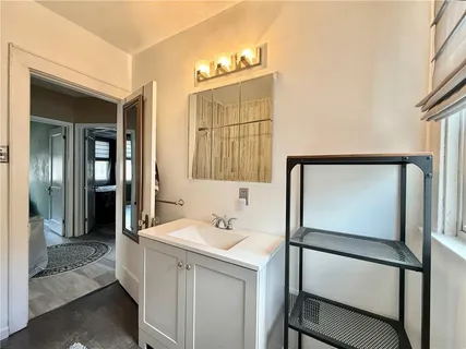 a bathroom with a sink a mirror and a shower