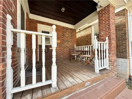 a view of a balcony with wooden floor