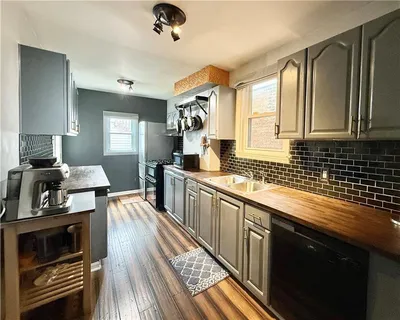 a kitchen with stainless steel appliances a sink stove and cabinets