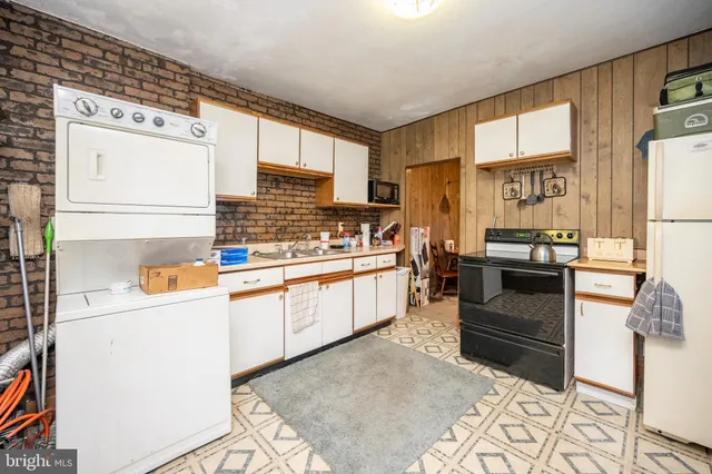 a kitchen with stainless steel appliances a stove a sink and a refrigerator