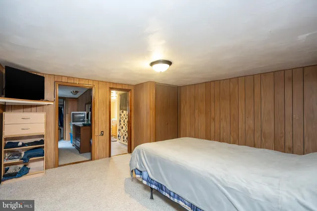 a bedroom with a bed and a television in it