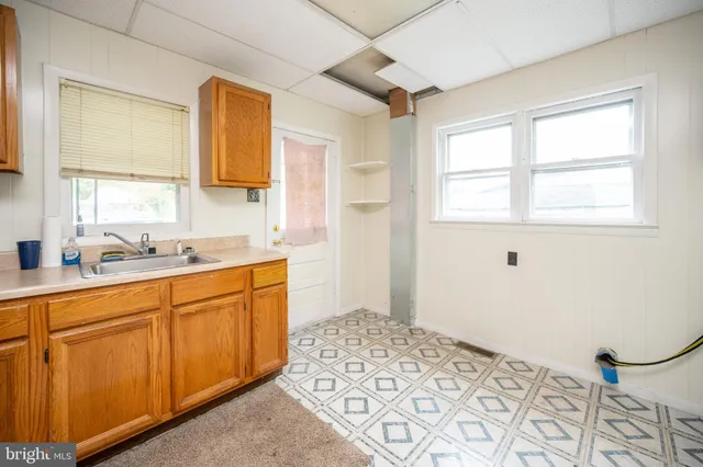 a utility room with cabinets washer and dryer