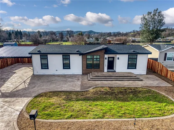 a view of a house with a swimming pool and a yard