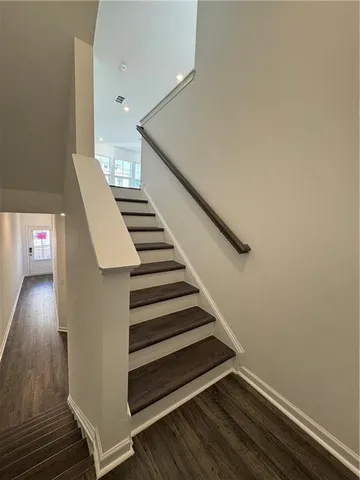 a view of entryway and hall with wooden floor