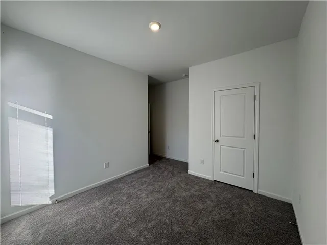 an empty room with closet area