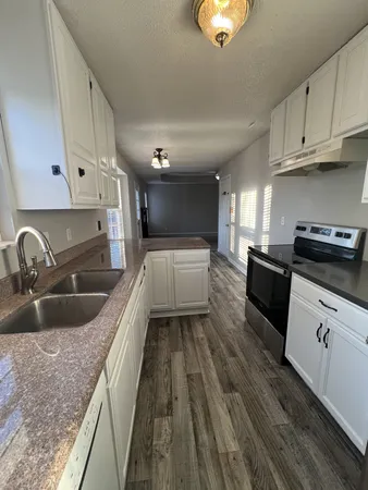 a kitchen with sink and cabinets
