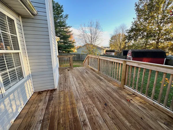 a view of balcony with wooden floor and fence