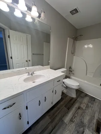 a bathroom with a double vanity sink and a toilet