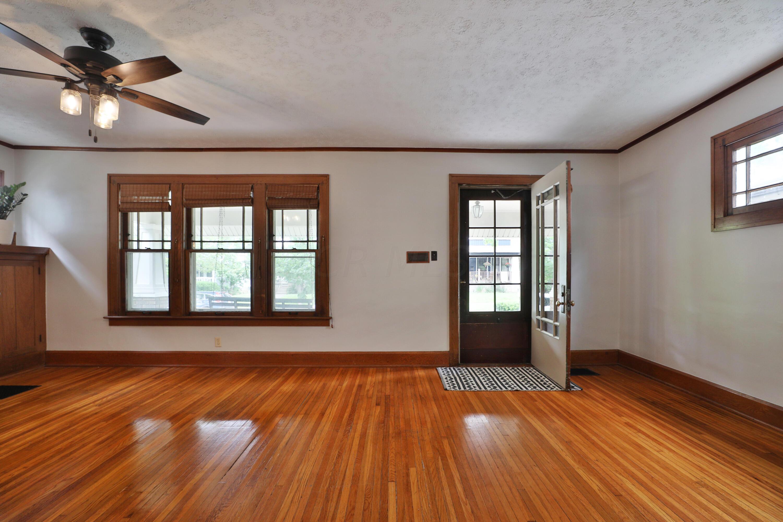 Spacious living room with gleaming hardwood floors