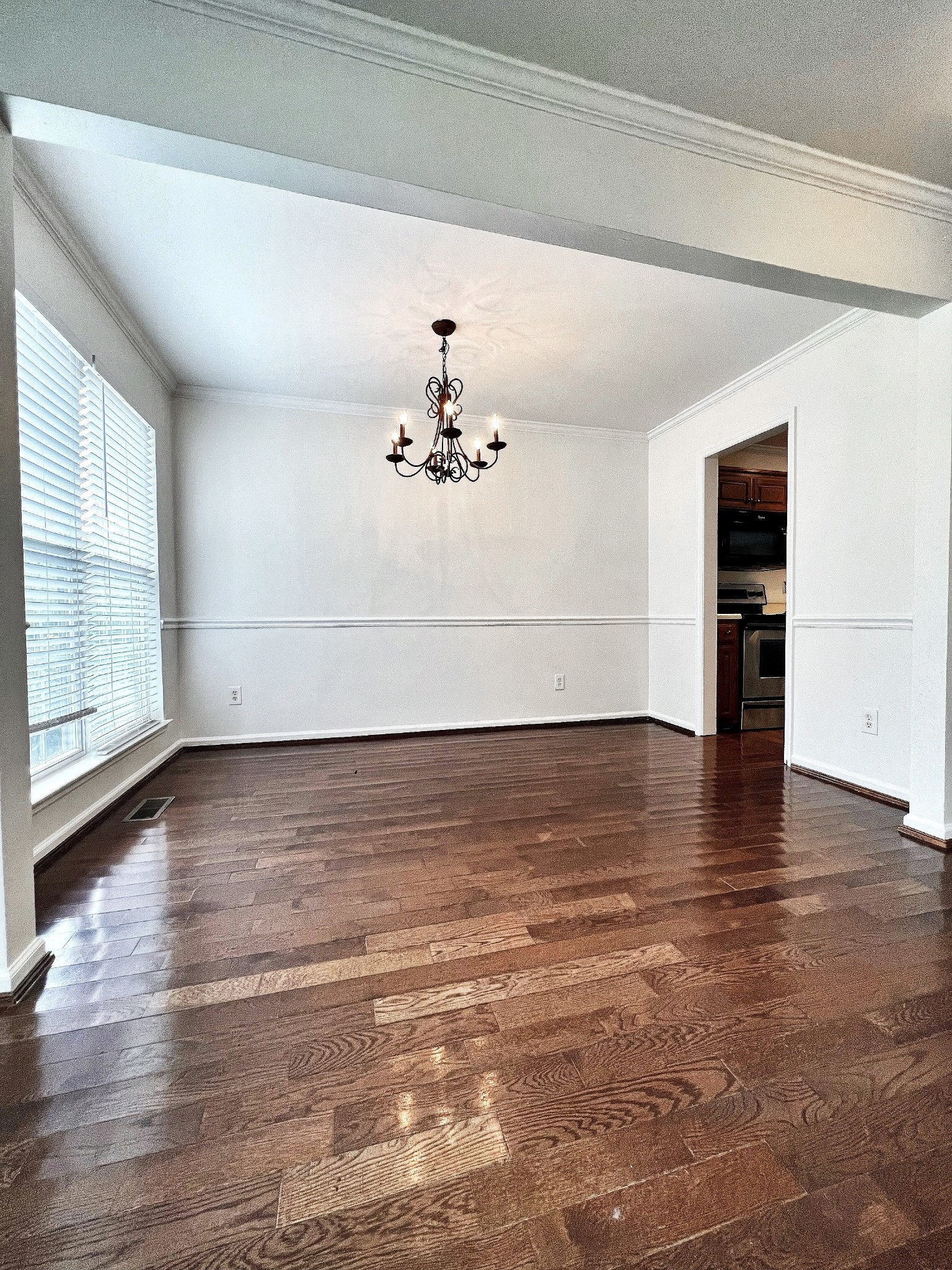 2817 Rader Ridge Court Antioch, TN 37013 - Photo 5 of 14 an empty room with wooden floor chandelier and windows