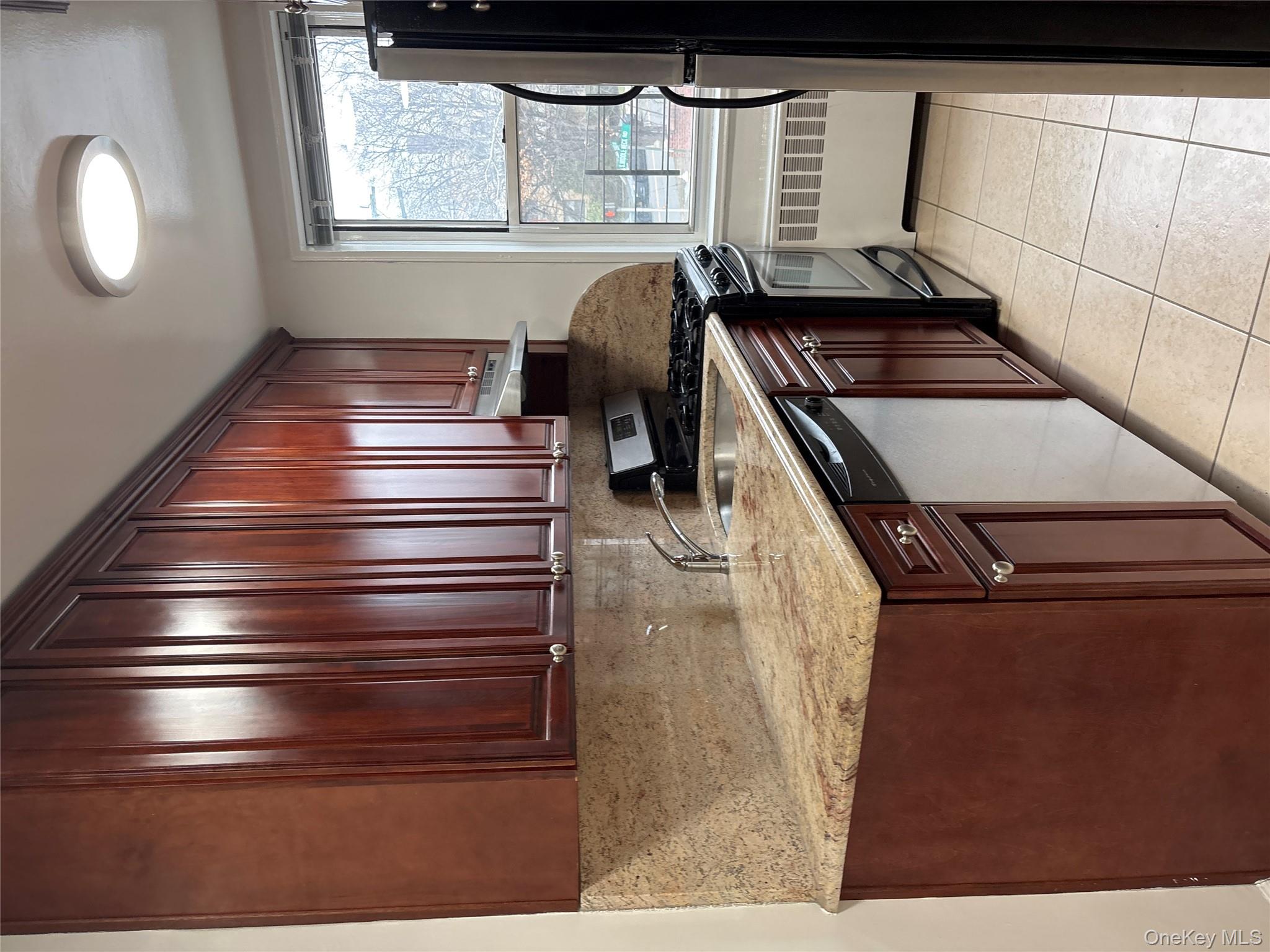 50 South Middle Neck Road, Unit 1P Great Neck, NY 11021 - Photo 8 of 22 Windowed updated kitchen with stainless steel appliances, range hood, stone counters and tons of cabinet space for incredible storage.