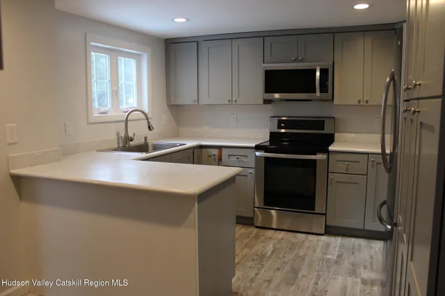 a kitchen with a white cabinets and a refrigerator