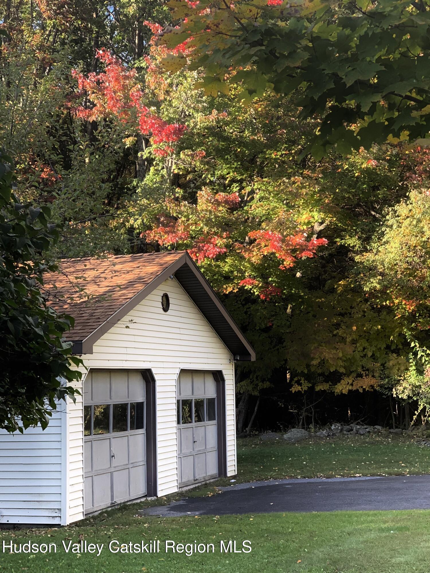 477 Campbell Road Windham, NY 12496 - Photo 44 of 45 a view of a white house with a yard and large tree
