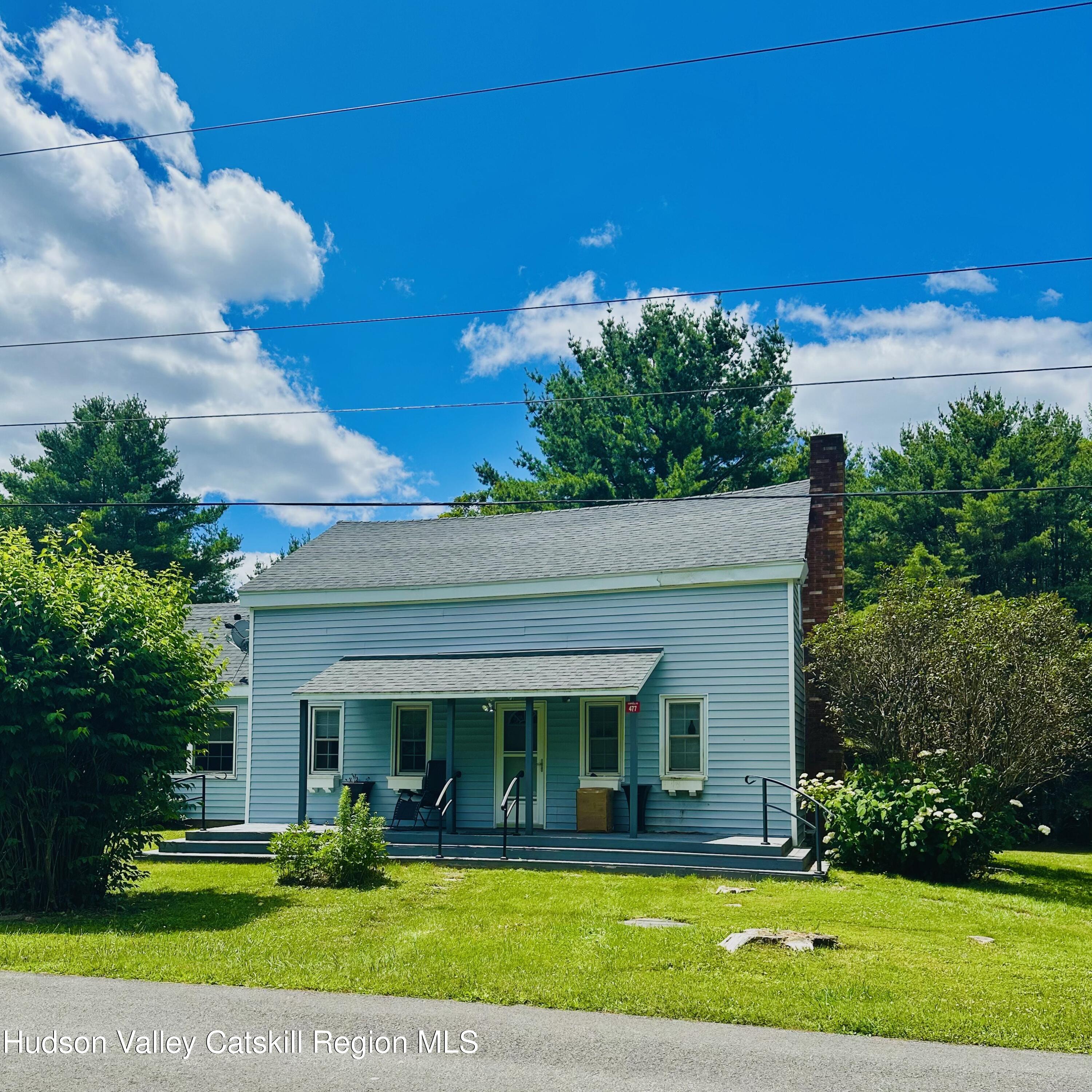 477 Campbell Road Windham, NY 12496 - Photo 5 of 45 a view of a white house with a swimming pool