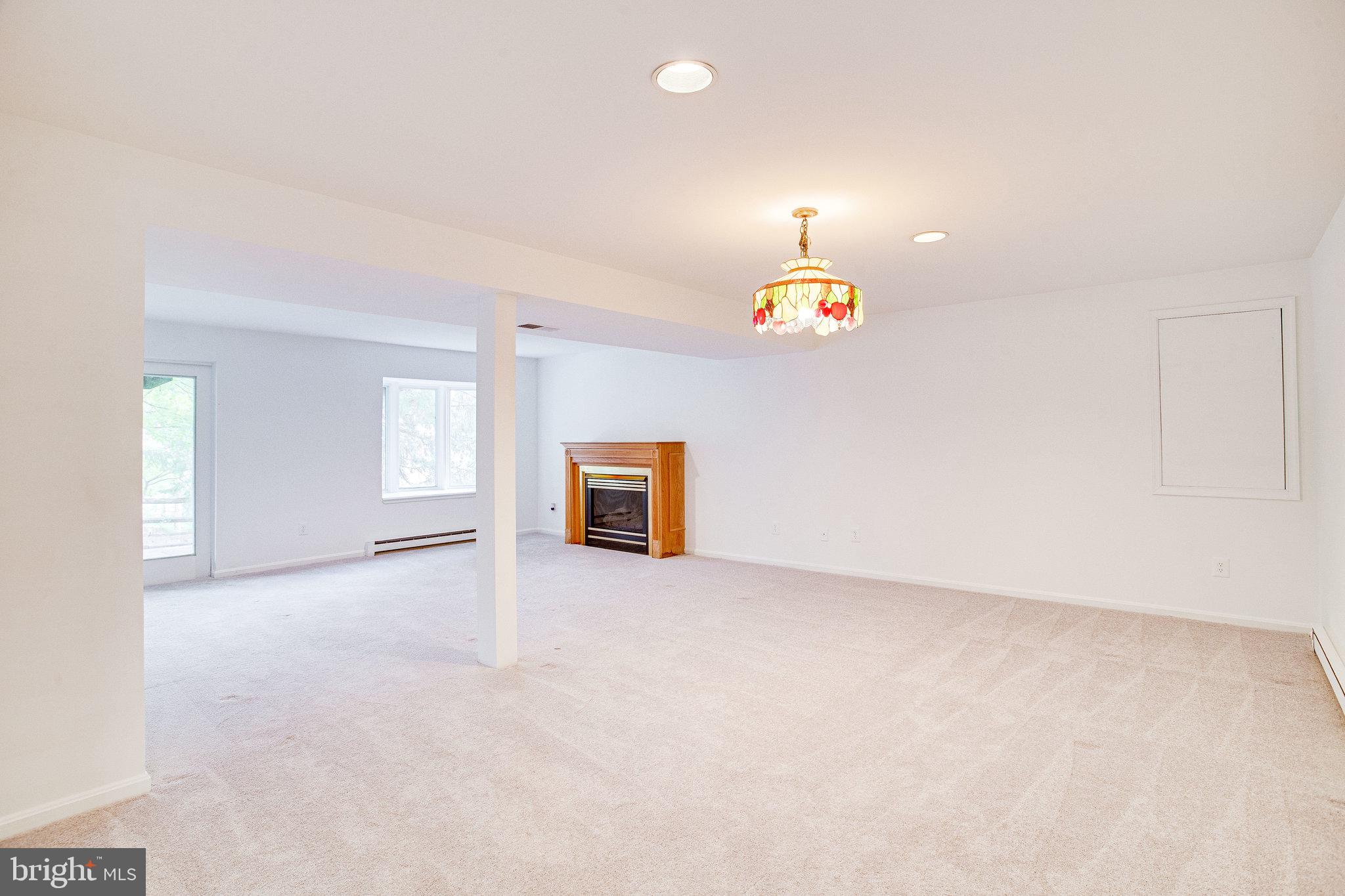 12220 St James Road Potomac, MD 20854 - Photo 45 of 69 Lower-level walkout rec room with gas fireplace