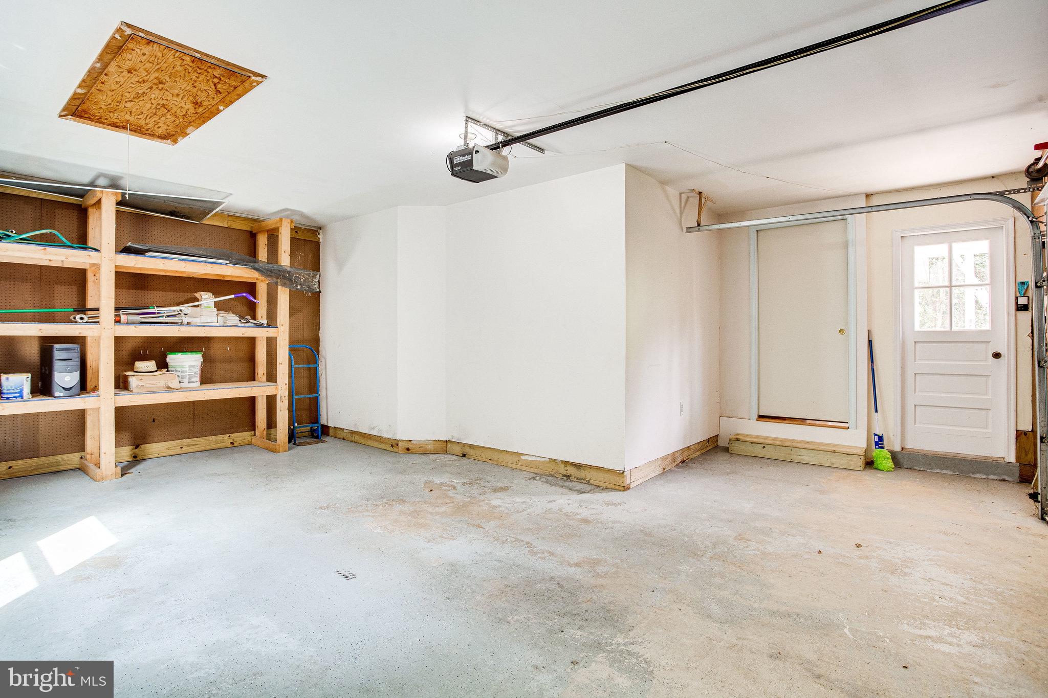 12220 St James Road Potomac, MD 20854 - Photo 54 of 69 Garage with built ins and pull down steps