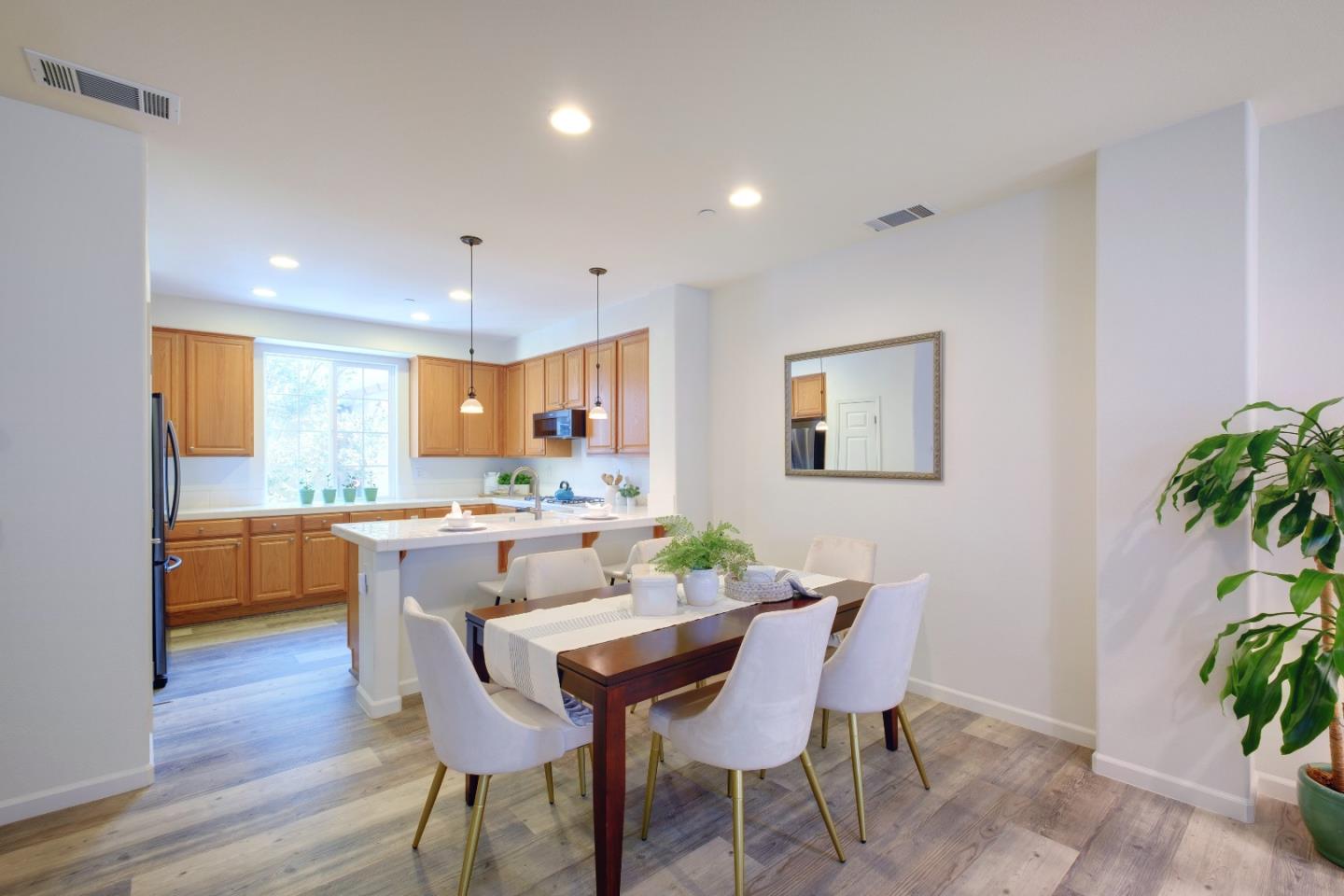 738 Claridad Loop Milpitas, CA 95035 - Photo 12 of 53 a view of a dining room with furniture and wooden floor