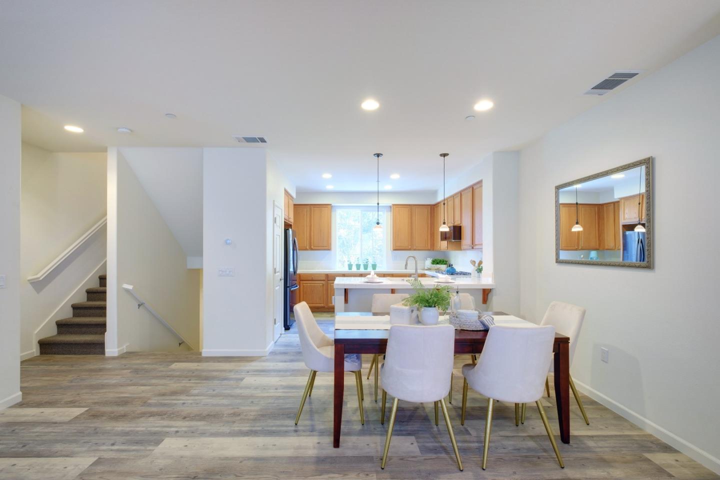 738 Claridad Loop Milpitas, CA 95035 - Photo 13 of 53 a view of a dining room with furniture and wooden floor