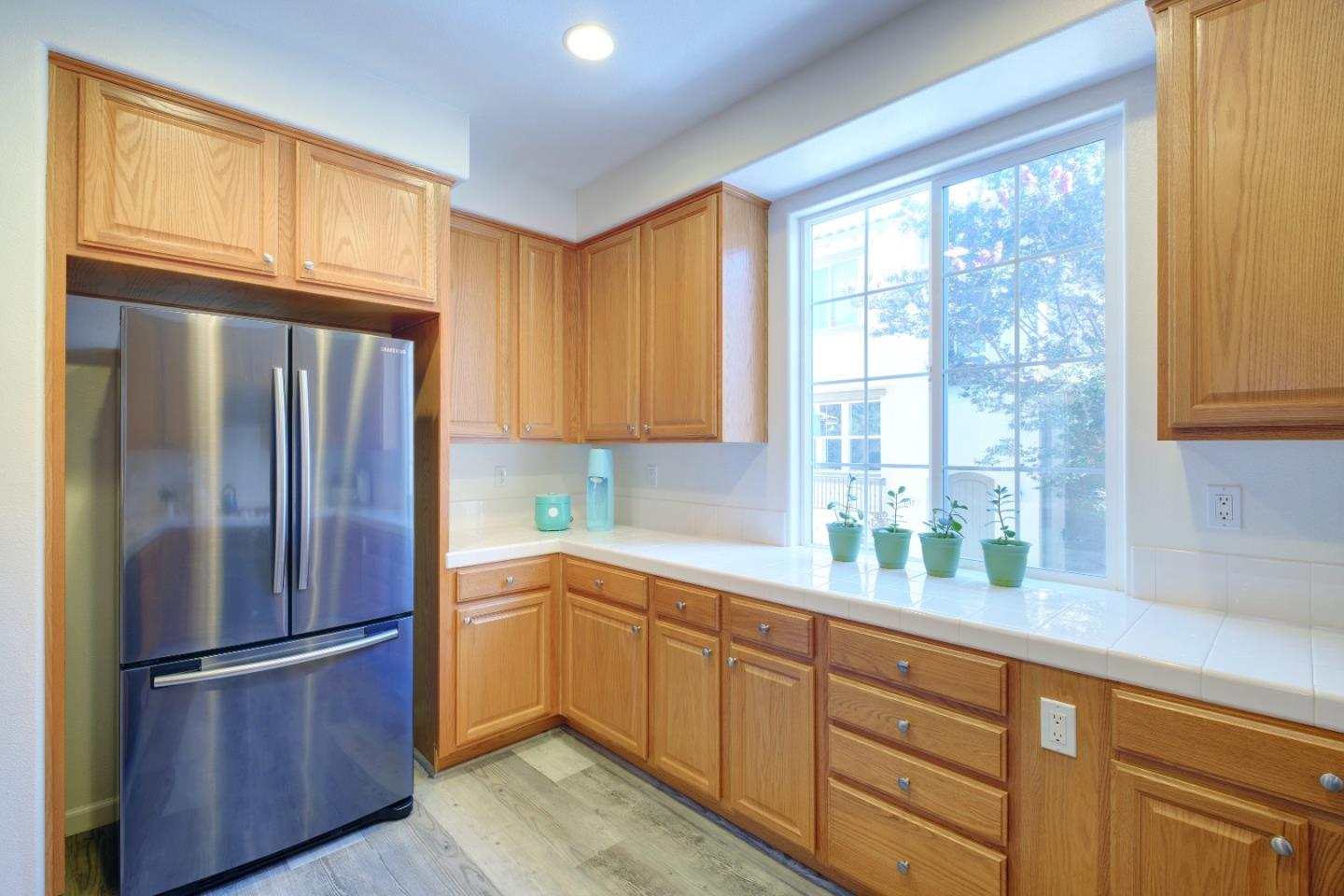 738 Claridad Loop Milpitas, CA 95035 - Photo 19 of 53 a kitchen with stainless steel appliances granite countertop a refrigerator sink and cabinets